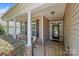 Inviting front porch with classic columns and decorative windows, offering a warm welcome to the home at 4527 Hubbard Falls Dr, Charlotte, NC 28269