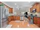 Well-lit kitchen features hardwood floors, stainless steel appliances, and granite countertops at 4527 Hubbard Falls Dr, Charlotte, NC 28269