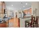 Open-concept kitchen with breakfast bar, hardwood floors, stainless appliances, and granite counters at 4527 Hubbard Falls Dr, Charlotte, NC 28269