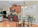 Cozy kitchen nook features hardwood floors and stainless steel appliances near a sun-filled window at 4527 Hubbard Falls Dr, Charlotte, NC 28269