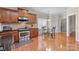 Cozy kitchen and breakfast nook features hardwood floors, stainless steel appliances and granite countertops at 4527 Hubbard Falls Dr, Charlotte, NC 28269