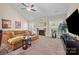 Bright living room features a fireplace, comfortable seating, large windows, and an open concept design at 4527 Hubbard Falls Dr, Charlotte, NC 28269