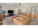 Relaxing living room boasts vaulted ceiling, comfortable seating, open-concept design, and a large TV at 4527 Hubbard Falls Dr, Charlotte, NC 28269