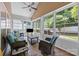 Sunroom features brick flooring, large windows, and comfortable seating at 4527 Hubbard Falls Dr, Charlotte, NC 28269