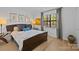 Comfortable bedroom with a well-lit window, hardwood floors, and stylish decor creating a relaxing atmosphere at 498 Glory Ct, Fort Mill, SC 29715