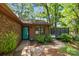 Inviting home entrance features a striking teal door, brick facade, and beautiful landscaping at 498 Glory Ct, Fort Mill, SC 29715