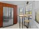 Bright kitchen with a stainless steel refrigerator, tiled floors, and a cozy dining area at 498 Glory Ct, Fort Mill, SC 29715