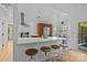 Modern kitchen featuring a breakfast bar with seating, stainless steel appliances, and plenty of natural light at 498 Glory Ct, Fort Mill, SC 29715