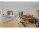 Bright living room featuring hardwood floors, white walls, and an open layout with kitchen view at 498 Glory Ct, Fort Mill, SC 29715