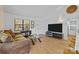 Spacious living area with hardwood floors, a large TV, and comfortable seating at 498 Glory Ct, Fort Mill, SC 29715