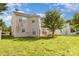 Spacious backyard featuring lush green grass, a mature tree, and the home's exterior at 5307 Ayers Orchard Way, Charlotte, NC 28227