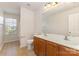 Bathroom with double sink vanity, toilet, and window, providing a functional space at 5307 Ayers Orchard Way, Charlotte, NC 28227