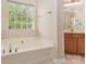 Bright bathroom showcasing a soaking tub beneath a window at 5307 Ayers Orchard Way, Charlotte, NC 28227