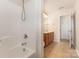 Bright bathroom with a combination tub and shower and wooden vanity with countertop at 5307 Ayers Orchard Way, Charlotte, NC 28227