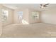 Spacious, carpeted bedroom with multiple windows and a ceiling fan at 5307 Ayers Orchard Way, Charlotte, NC 28227