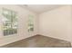 View of vacant bedroom showing two windows and light brown flooring at 5307 Ayers Orchard Way, Charlotte, NC 28227
