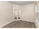 This bedroom features a window, french doors and wood look laminate flooring at 5307 Ayers Orchard Way, Charlotte, NC 28227