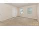 Bright bedroom with neutral walls, carpet, and natural light from two windows at 5307 Ayers Orchard Way, Charlotte, NC 28227