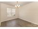 Dining room with modern chandelier and large window, creating an inviting atmosphere at 5307 Ayers Orchard Way, Charlotte, NC 28227