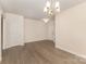 Spacious dining room with hardwood floors, a modern chandelier and access to other rooms at 5307 Ayers Orchard Way, Charlotte, NC 28227