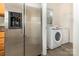 Adjacent to the stainless steel refrigerator, the laundry room includes a washer and dryer at 5307 Ayers Orchard Way, Charlotte, NC 28227