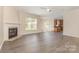 Open-concept living room with fireplace and easy access to kitchen and backyard at 5307 Ayers Orchard Way, Charlotte, NC 28227