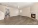 Bright living room featuring a cozy fireplace and modern flooring at 5307 Ayers Orchard Way, Charlotte, NC 28227