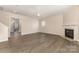 Bright living room featuring a cozy fireplace and modern flooring at 5307 Ayers Orchard Way, Charlotte, NC 28227