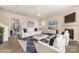 Bright living room features a fireplace, TV, white furniture, ceiling fan, and modern decor at 5307 Ayers Orchard Way, Charlotte, NC 28227