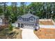 Aerial shot of two-story house highlighting its well-kept lawn, privacy fence, and attached two-car garage at 6425 Pamela St, Huntersville, NC 28078