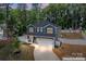 Aerial view of home with gray siding, a well-manicured lawn, privacy fence, and attached two-car garage at 6425 Pamela St, Huntersville, NC 28078