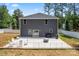 Lovely back exterior featuring a patio area, a grill, seating, and lush landscaping for outdoor relaxation at 6425 Pamela St, Huntersville, NC 28078