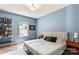 Serene bedroom with hardwood floors, soft blue walls, and a cozy, inviting ambiance at 6425 Pamela St, Huntersville, NC 28078