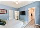 Relaxing bedroom with blue accent walls, hardwood floors, and ensuite bathroom access at 6425 Pamela St, Huntersville, NC 28078