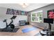Spacious workout area with a stationary bike, rowing machine, and large window at 6425 Pamela St, Huntersville, NC 28078