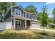 Inviting two-story home featuring gray siding, brick accents, a covered porch, and attached two-car garage at 6425 Pamela St, Huntersville, NC 28078