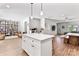 Open-concept kitchen featuring a white island, pendant lighting, and seamless flow to living spaces at 6425 Pamela St, Huntersville, NC 28078