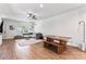 Bright living room with gray sectional sofa, wooden dining table, and open concept view of the room at 6425 Pamela St, Huntersville, NC 28078
