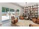 Bright living room featuring custom bookshelf, inviting seating area, and access to the outdoors at 6425 Pamela St, Huntersville, NC 28078