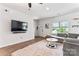 Bright living room with gray sectional sofa, area rug, and a large window for natural light at 6425 Pamela St, Huntersville, NC 28078