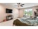 Cozy main bedroom featuring a mounted TV, stylish furniture, and plenty of natural light at 6425 Pamela St, Huntersville, NC 28078