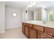 Primary bathroom featuring double vanity, tile floor and a large mirror at 704 Millstream Dr, Rock Hill, SC 29732