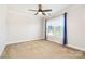 This bedroom features neutral carpet, a ceiling fan, and a window with plenty of natural light at 704 Millstream Dr, Rock Hill, SC 29732