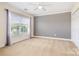 Carpeted bedroom with neutral walls, white trim, a ceiling fan, and large window at 704 Millstream Dr, Rock Hill, SC 29732