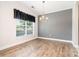 Dining room featuring wood floors, natural light from window and stylish light fixture at 704 Millstream Dr, Rock Hill, SC 29732