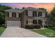 Charming brick two-story home featuring a two-car garage and covered front porch at 704 Millstream Dr, Rock Hill, SC 29732