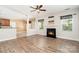Open-concept living space with hardwood floors, fireplace, and a view into the kitchen area at 704 Millstream Dr, Rock Hill, SC 29732