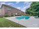 Brick home with a backyard pool, lush landscaping and a serene outdoor living space at 704 Millstream Dr, Rock Hill, SC 29732