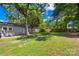 A large, grassy backyard with mature trees and a pathway, offering a serene outdoor space at 716 W Graham St, Shelby, NC 28150
