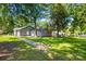 Expansive backyard featuring lush greenery and mature trees providing ample shade at 716 W Graham St, Shelby, NC 28150